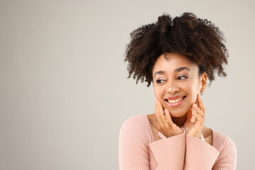 Portrait of beautiful Brazilian woman on gray background, space for text