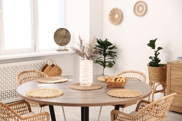 Stylish table with chairs and decor in dining room. Interior design