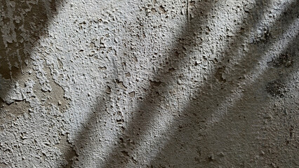 close-up rough weathered texture old cement wall with peeling, cracked white paint. Wall surface...