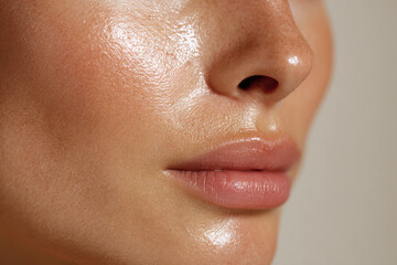 Close up of dewy skin texture with moisturizer on face