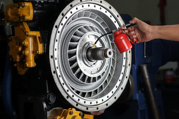 Mechanic hand lubricating bearings with oil can On stator and converter pump automatic transmission.