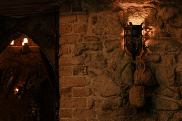 fantasy cave torch on cold stone wall underground corridor medieval bat and blurred background behind corner objecr