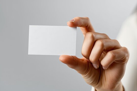Close-up of a hand holding a blank business card
