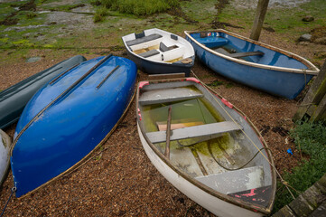 Small boats at the quay on the River Deben in the historic town of Woodbridge in Suffolk, UK.