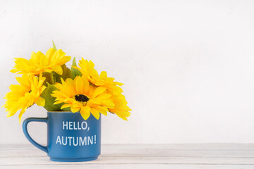 Hello autumn fall seasonal and holiday background, with a bouquet of sunflower flowers, plaid and...