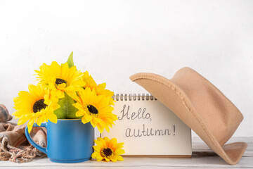 Hello autumn fall seasonal and holiday background, with a bouquet of sunflower flowers, plaid and...