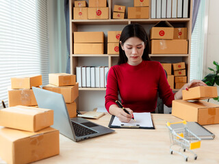 Small business entrepreneurs, SMEs, and independent startups use laptops and boxes to receive and...