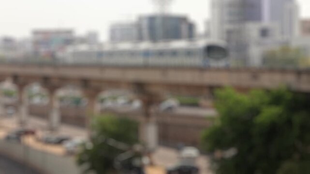 Bokeh view of moving train of Rapid Metro, it is a light metro system which connects the commercial areas of Dlf Cyberhub Cybercity Gurugram, New Delhi, India. Blurred background footage.