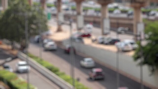 Bokeh view of road traffic and the office buildings of Dlf Cyberhub Cybercity Gurgaon Gurugram, New Delhi, India. Blurred background footage.
