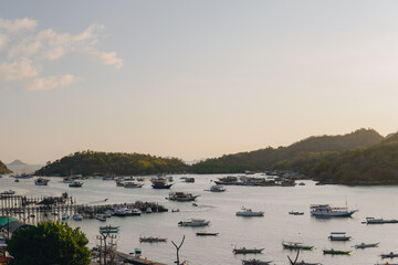 Beautiful seascape of Labuan Bajo with a collection of traditional boats Pinisi schooner sailing.