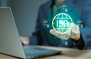 Businessman using digital interface for ISO certification and compliance verification, showing...