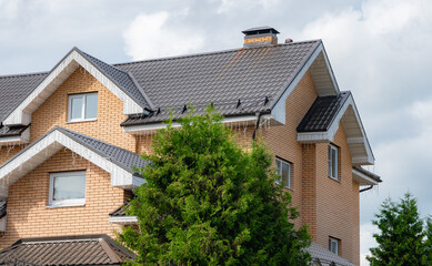 Elegant House with Modern Roof Tiles and Chimney View