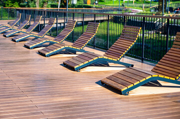 Empty Wet Wooden Lounge Chairs on Outdoor Deck