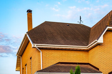 Elegant House with Modern Roof Tiles and Chimney View