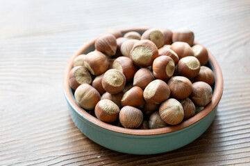 Fresh Turkish hazelnuts in shell in bowl in close-up