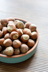 Fresh Turkish hazelnuts in shell in bowl in close-up