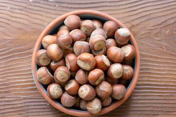 Fresh Turkish hazelnuts in shell in bowl in close-up
