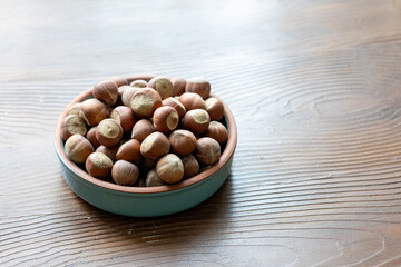 Fresh Turkish hazelnuts in shell in bowl in close-up