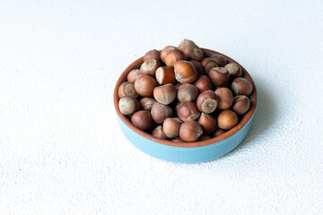 Fresh Turkish hazelnuts in shell in bowl in close-up