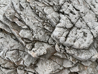 A close-up view of textured, gray rock layers showcasing intricate patterns and natural formations.