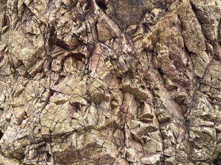 A close-up view of textured rock surfaces showcasing intricate patterns and natural formations,...