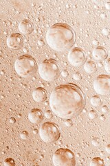 Close-up of  water droplets on a pale peach surface