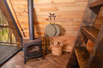 A rustic cabin scene showcasing a wood stove, wooden wall paneling, and charming decor elements....