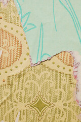 Old torn wallpaper on the wall.Old wallpaper for texture or background.