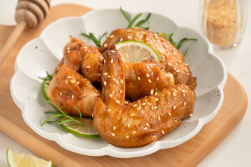 Honey Lemon Glazed Chicken Wings with Sesame and Lime.