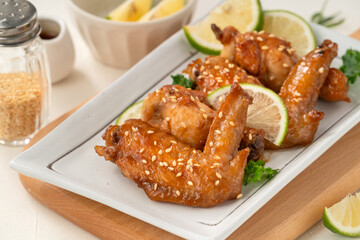 Honey Lemon Glazed Chicken Wings with Sesame and Lime.