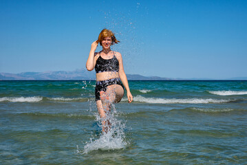 Woman splashing water in the sea