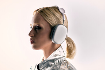 Futuristic blonde woman showcasing avant-garde fashion in a sleek studio setup