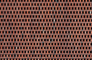 Red brick wall with geometric ventilation pattern