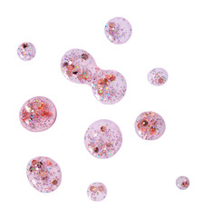 Nail polish drops isolated over white background