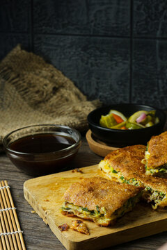 Martabak telur. Egg martabak or thick folded crepe made from egg, meat, and vegetables.
