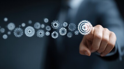 Hand pointing to gears on digital interface