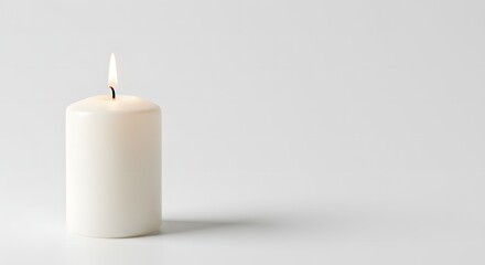A single, lit white candle casting a soft shadow against a plain, light background.