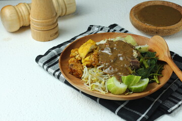 Rujak cingur. javanese vegetable salad with rice cake and cow mouth. with peanut sauce.