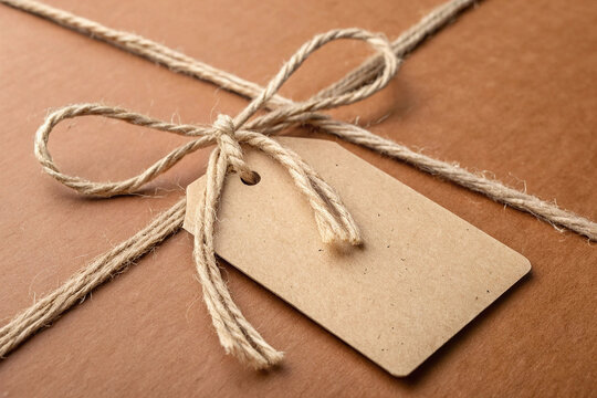 Kraft Paper Tag Tied with Twine on Brown Cardboard Package