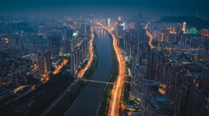 Fototapeta premium Night cityscape Aerial view of illuminated city skyline at dusk river and highway
