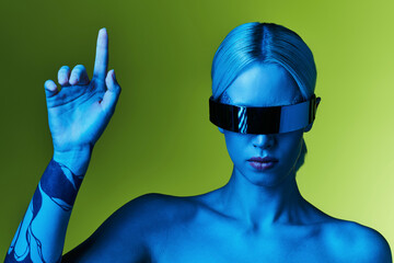 Futuristic fashion look with a young blonde woman in striking sunglasses and outfit