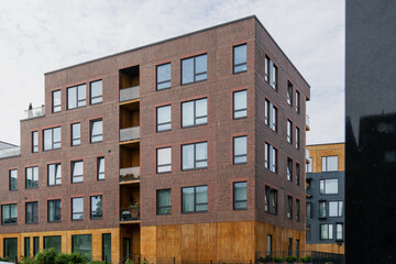Modern residential apartment building with brick facade and large windows contemporary urban housing architecture Tallinn property real estate construction infrastructure exterior detail