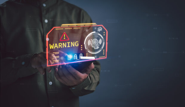 Person holding mobile phone with holographic AI warning interface, representing cybersecurity threats, malware detection, data security, futuristic technology, and advanced risk prevention concept - Powered by Adobe