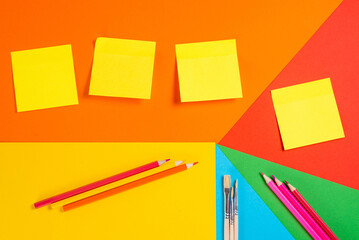 Sticky Notes and School Supplies on Geometric Background