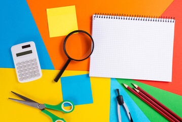 Notebook with School Supplies on Geometric Background