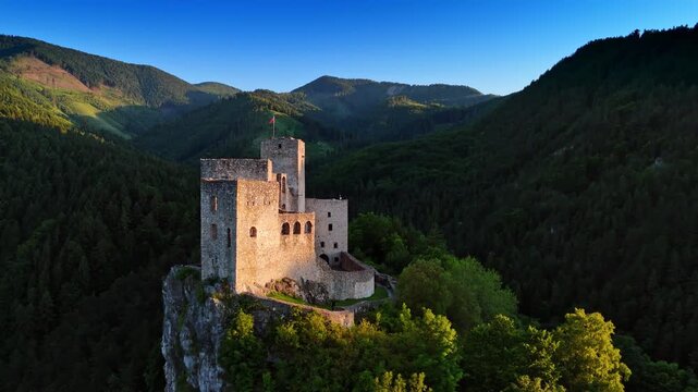 Mediaeval castle with the flag on top of the mountain. Travelling by the landmarks of Slovakia.