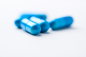 Amino acids capsules on bright background. Soft focus. Close up. Copy space.	