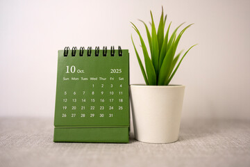 The desktop calendar for October 2025 is on the desk, where there is a place to copy.
