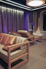 Softly padded loungers inside relaxation tea room in thermal suite wellness area onboard luxury...