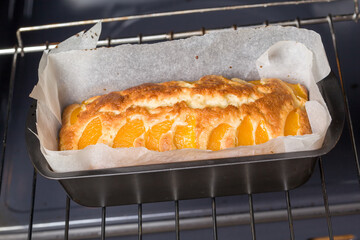Pie with peaches is baked in a oven